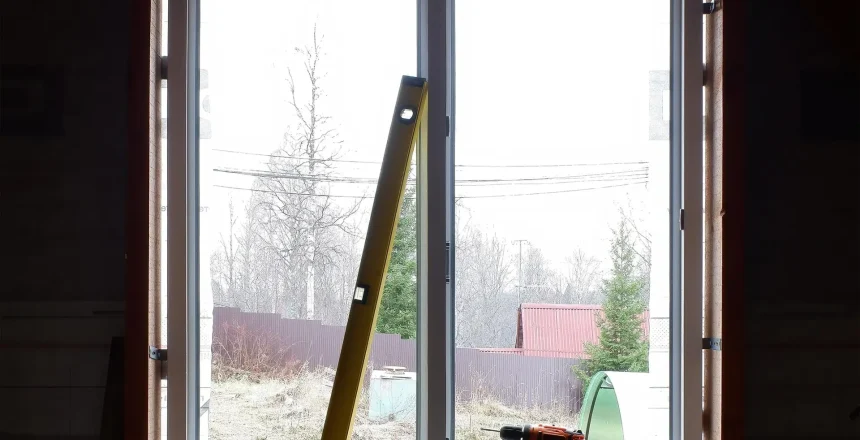installation of windows in a frame house. the level and the screwdriver on the background of the installed window. copy space.